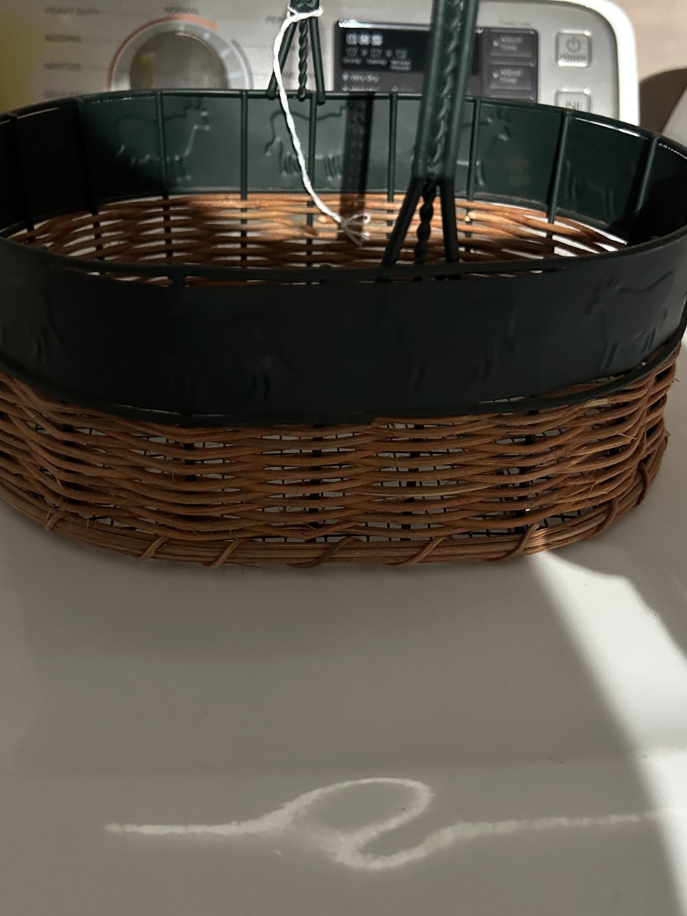 vintage oval gathering basket with a dark green metal frame.